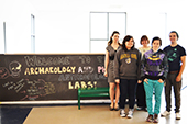 Photo: Anthropology students and professors pose in front of Anthropology welcome sign