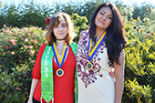 Photo: Anthropology graduates Nina and Sarah with medals
