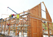 Workers working on the construction of the barn