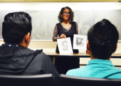 Professor Cat Ramirez shows images to her students.