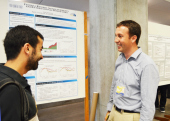 Eric Fischer, Economics with his poster presentation, "Federal Reserve Announcements and International Bond Flows."