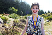 Photo: Anthropology graduate poses with medallion