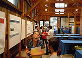 Attendees interacting with research